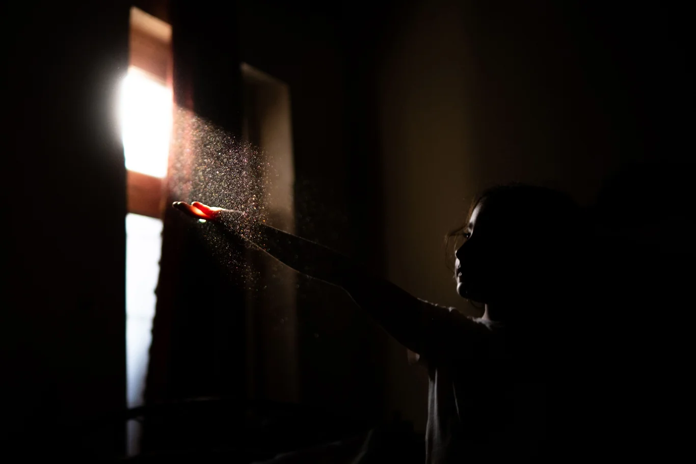 Sunlight through a window revealing dust particles drifting in the air
