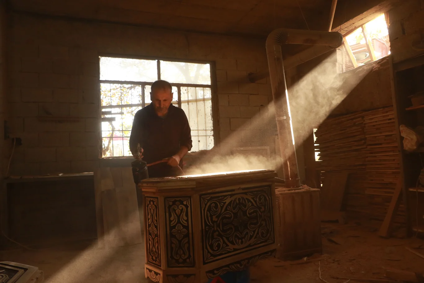 Dust particles floating visibly in a sunbeam inside a dim room