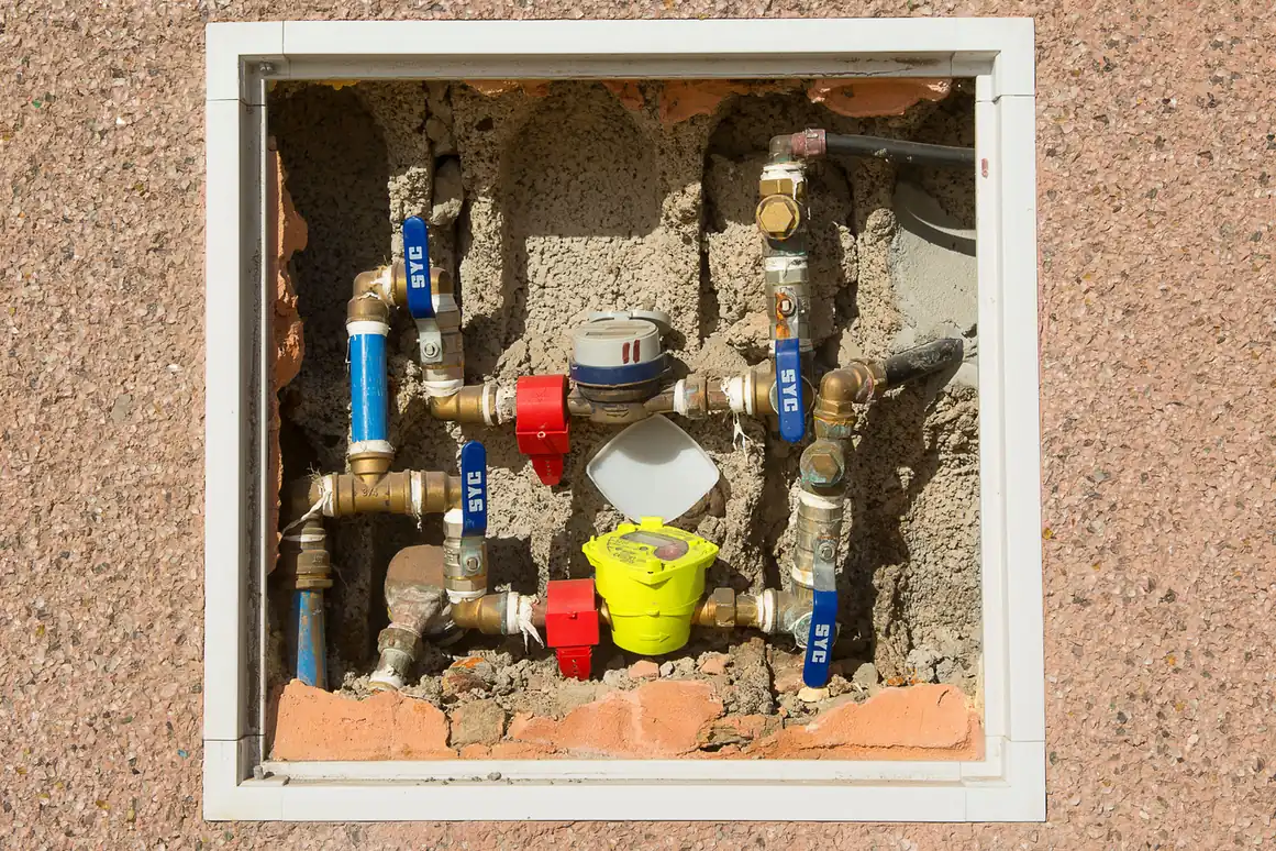 Whole-house filter and shutoff valves mounted on the main water supply line