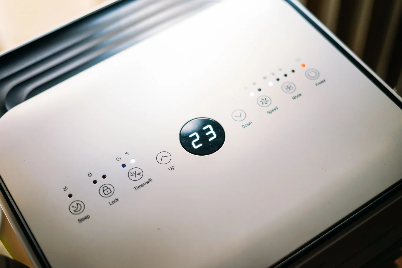 Digital display and touch buttons on an air purifier's top control panel