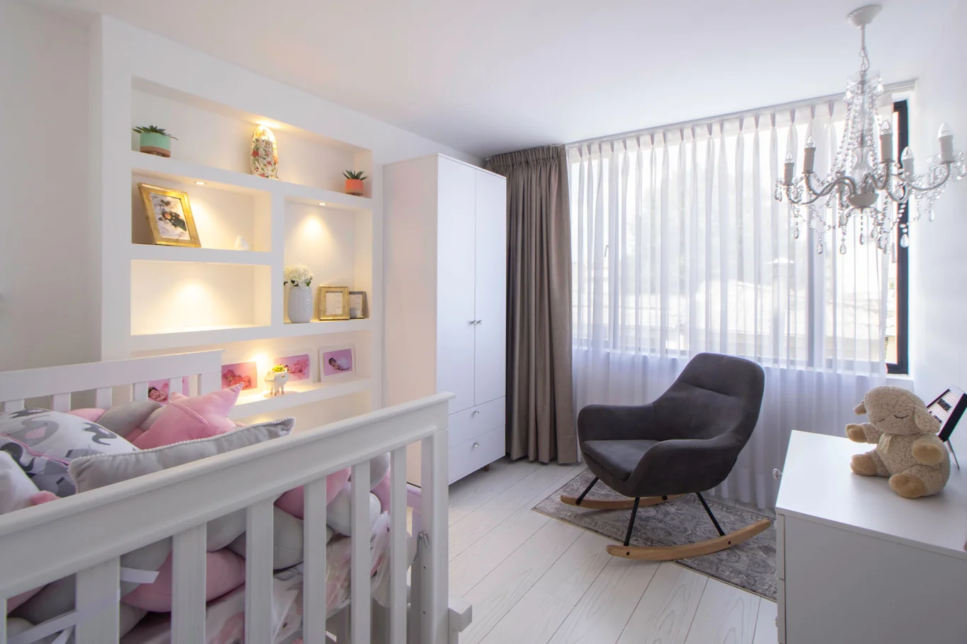 Bright nursery room with a crib and a rocking chair