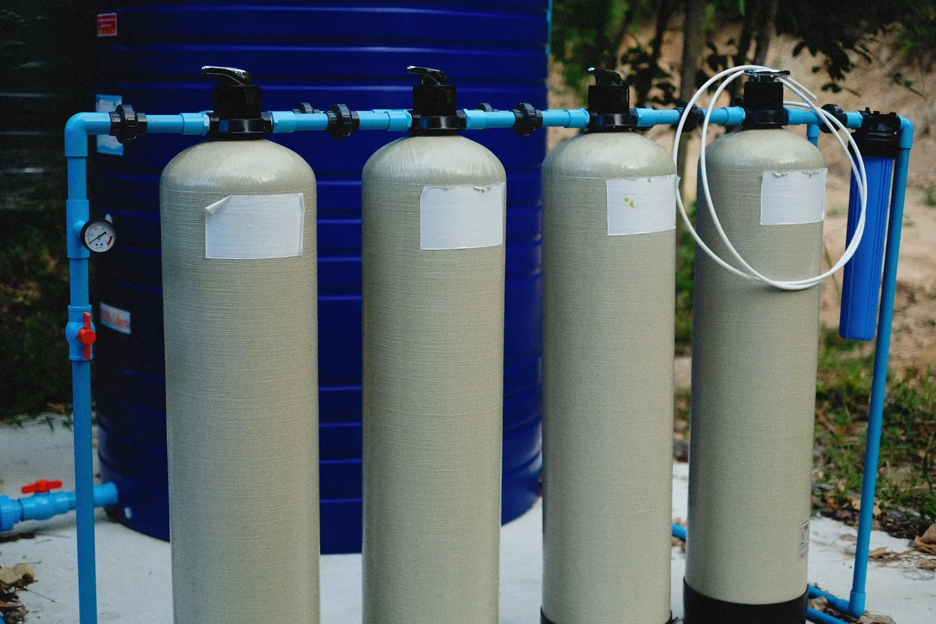 Water treatment tanks connected together for a well water filtration setup