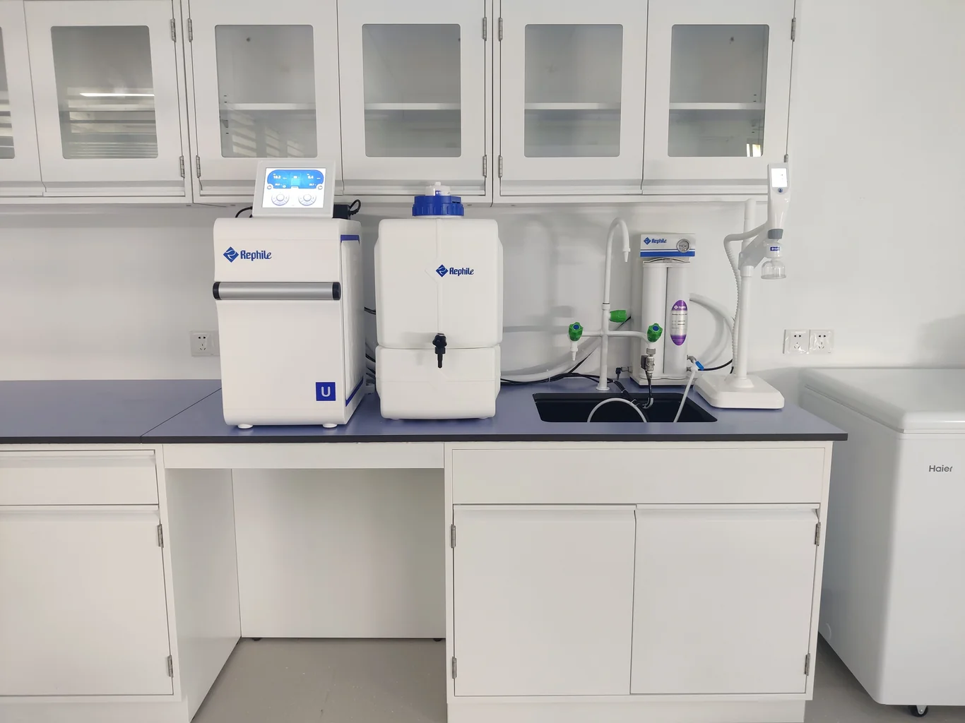 Reverse osmosis filter tanks connected by tubing on a counter